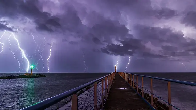 Lightning during an overnight storm at the port and lighthouse in Port-la-Nouvelle in the Aude department in southern …